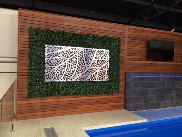 Artificial Hedge Panels Installed at A Pool Shop Display with Metal Wall Art
