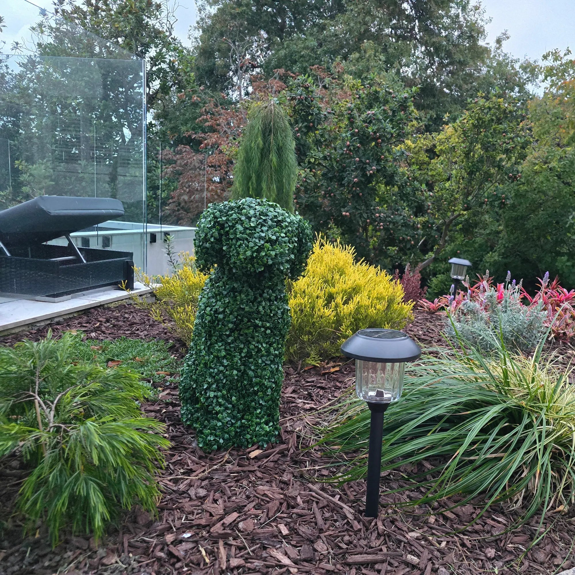 60cm UV resistant dog topiary styled in outdoor space from day to night