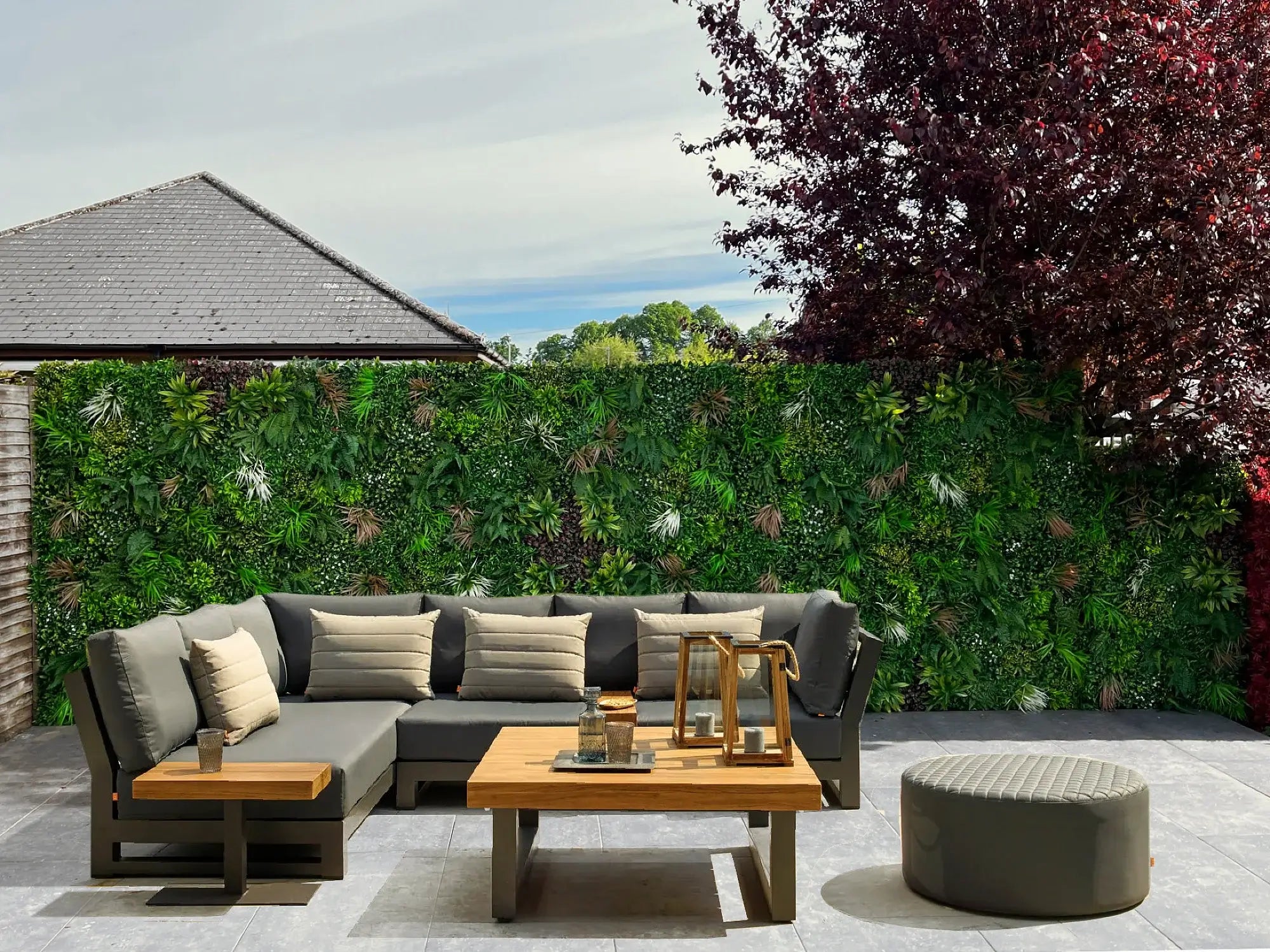 Backyard renovation with plastic plant wall panels and extra foliage added into the panels