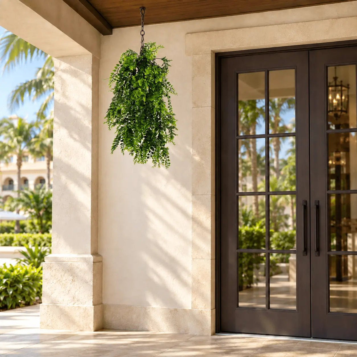 30-inch UV-resistant dense tropical fern artificial hanging plant on a covered hotel terrace