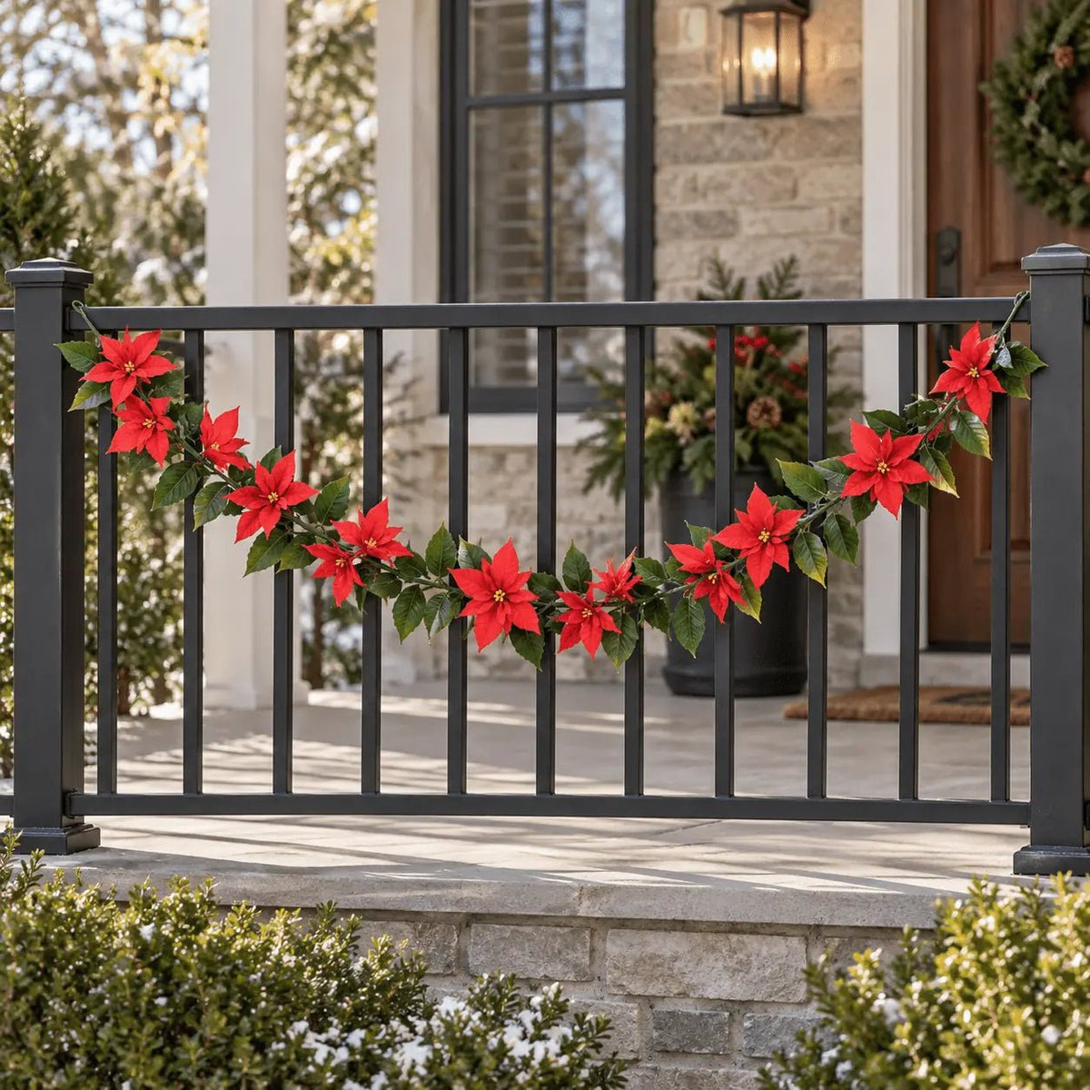 63-inch UV-resistant artificial poinsettia garland draped across an outdoor porch railing