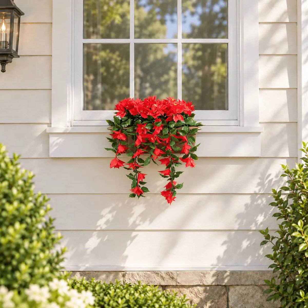 20 by 14-inch UV-resistant draping poinsettia artificial window box installed beneath an outdoor window