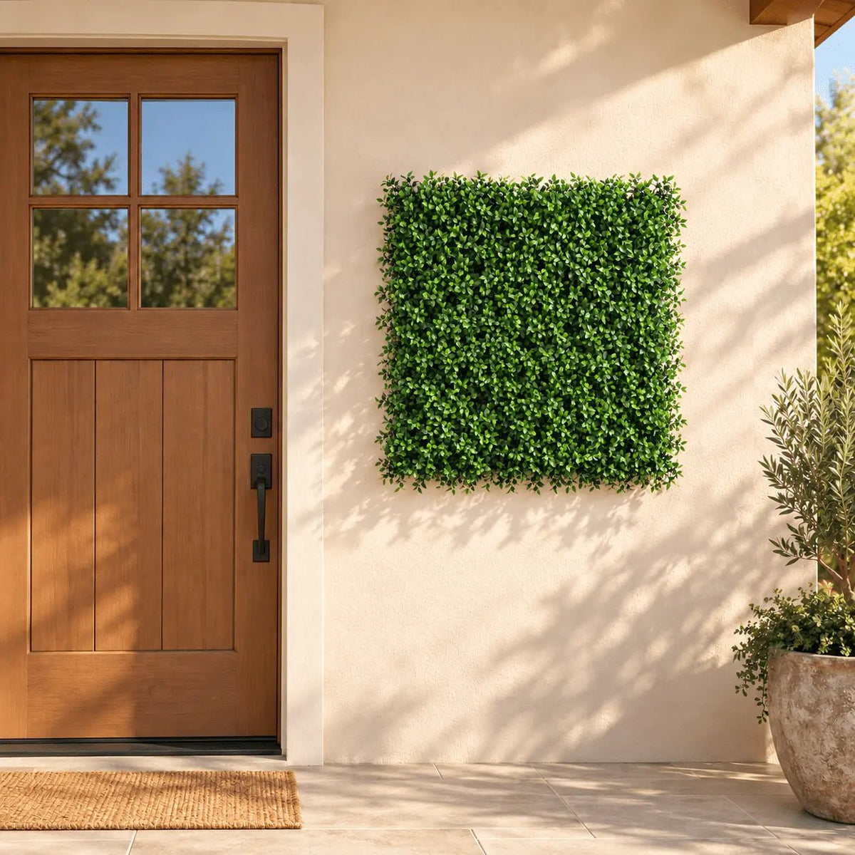 40 by 40-inch UV-resistant artificial ruscus green wall panel installed beside an outdoor entry door