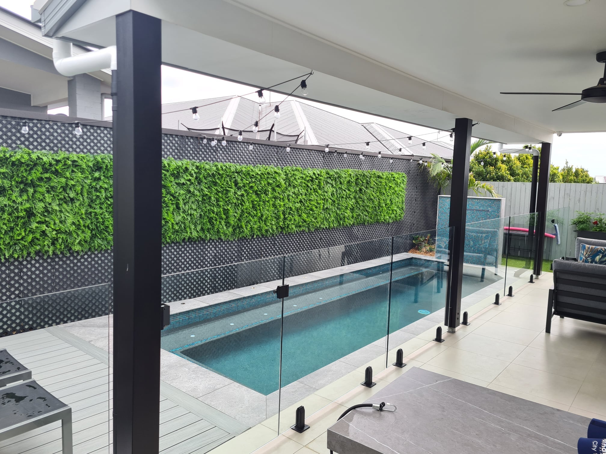 Artificial Green Wall Art along a Pool Fence