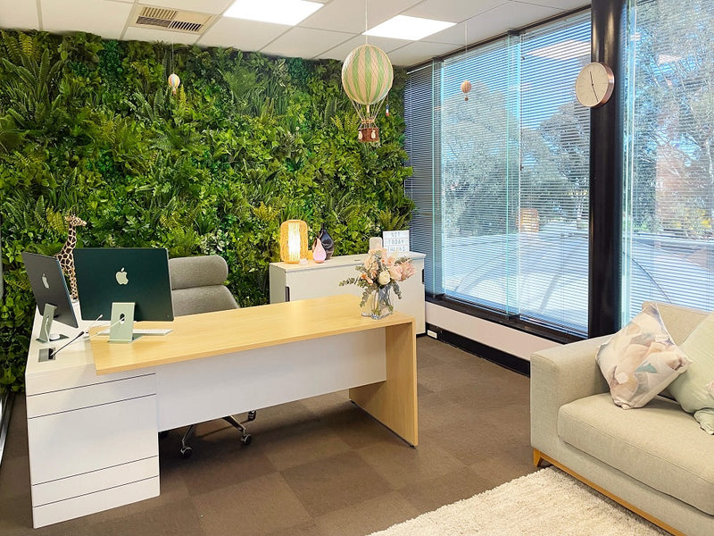 artificial green wall installed behind working desk