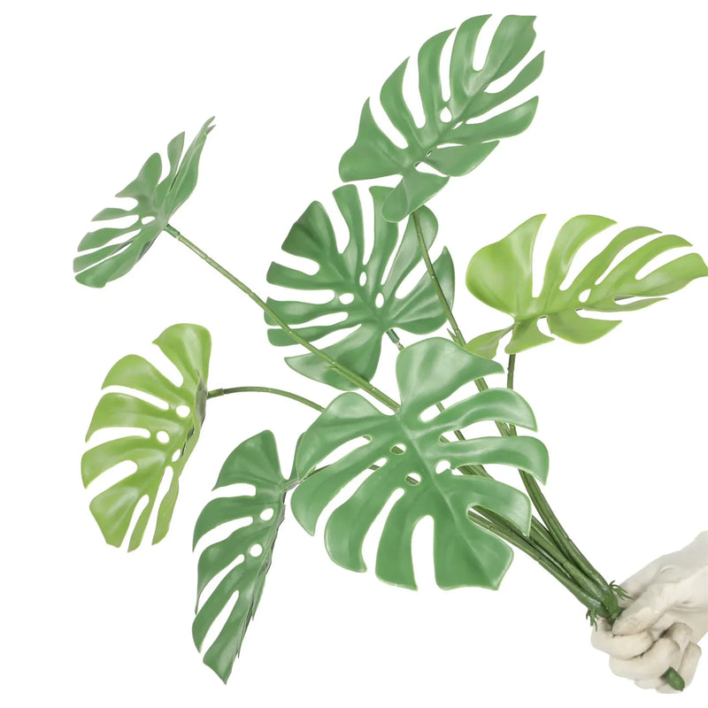 Faux monstera leaf in vibrant green, designed to withstand the elements without fading.