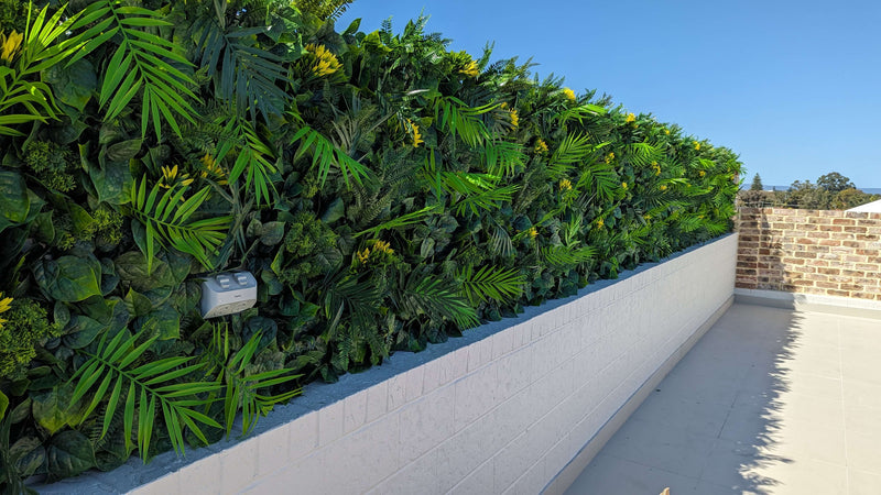 Faux Flowering Artificial Green Wall Panels on a roof top garden miami
