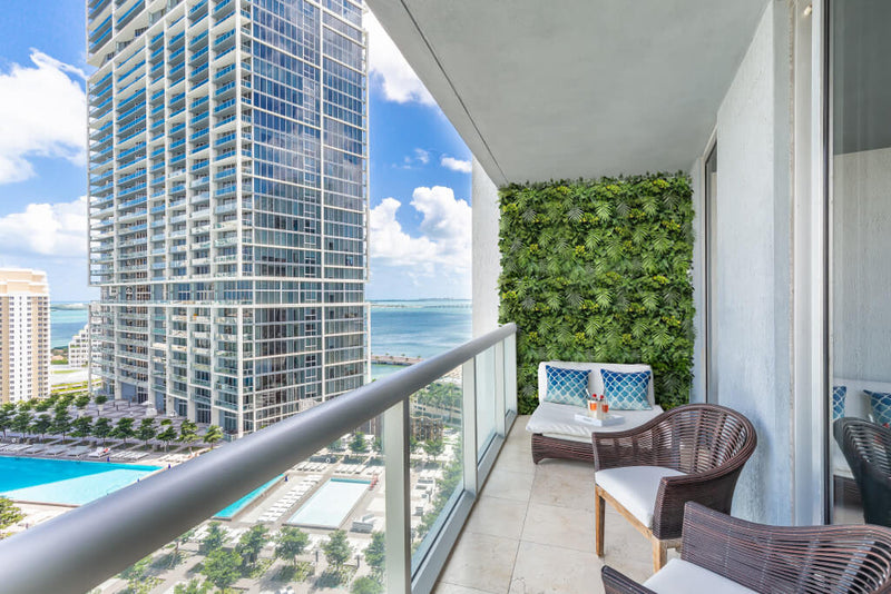 Premium Fern Artificial Green Wall Panel with Flowers on a Balcony in Miami