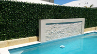 Artificial Hedge Panels Along a Pool Fence Wall