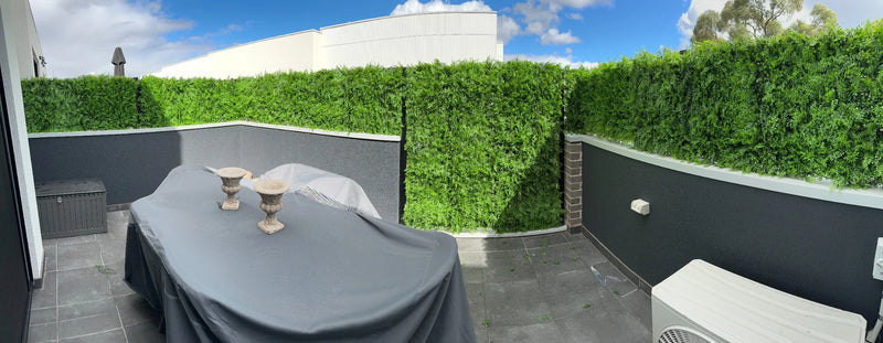 Balcony backyard area with dense fern artificial living wall panels