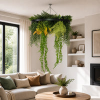 Artificial green wall disc with cascading trailing plants and layered foliage displayed above a modern living room with neutral décor and natural light.