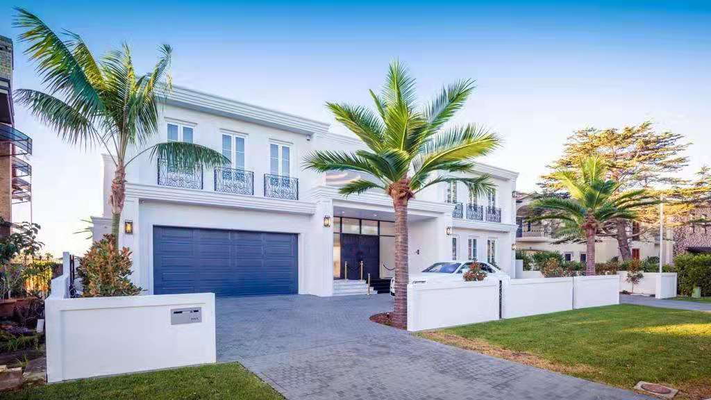 Modern house with palm trees and a clear blue sky