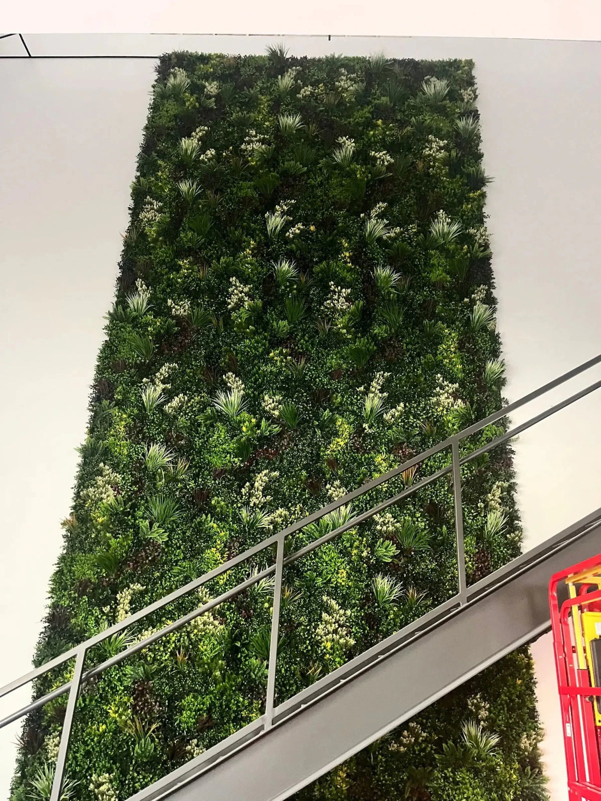 Evergreen Triptych Artificial Vertical Garden Green Wall Panel Set of 3 covering 33 sq ft, featuring realistic mixed evergreen foliage and layered tropical greenery. UV resistant, commercial-grade artificial green wall panels ideal for feature walls, privacy screens, offices, hospitality venues, retail displays, and outdoor landscape projects.