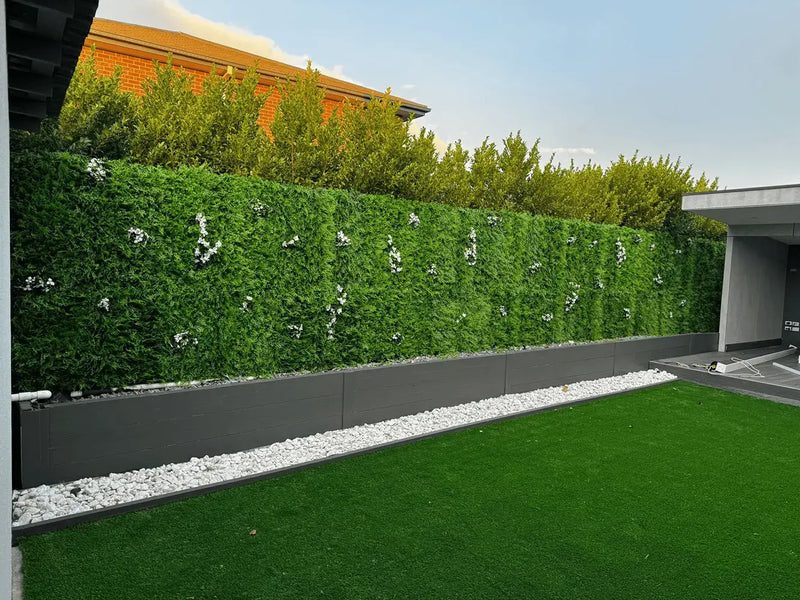 Artificial green plant wall in a modern outdoor garden area