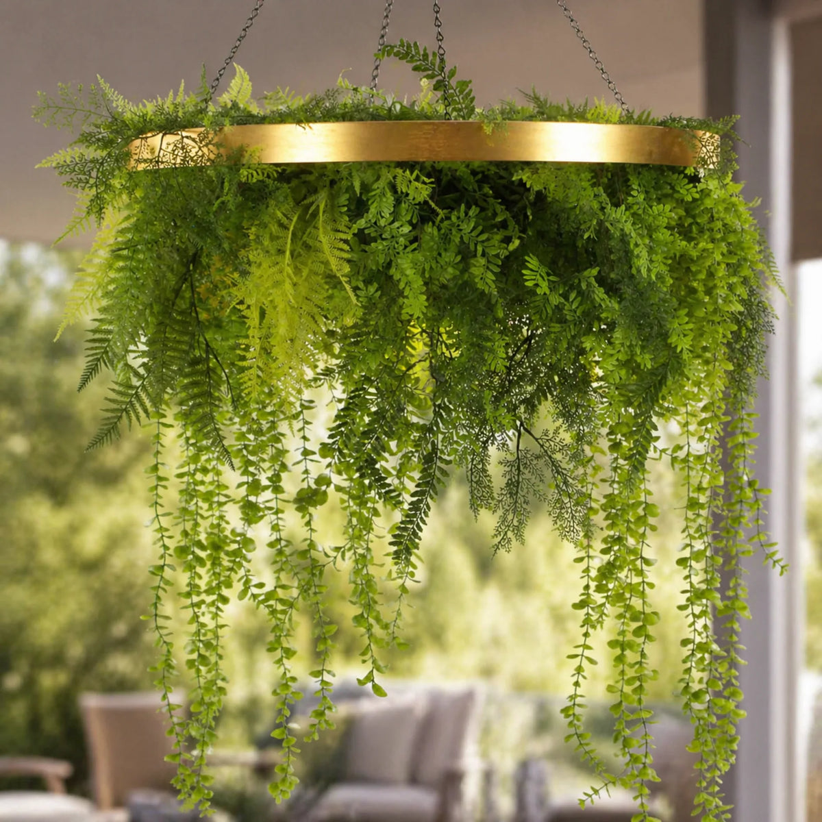 Close-up of a limited edition imitation gold hanging green wall disc featuring cascading artificial greenery and trailing UV resistant foliage suspended by chains.