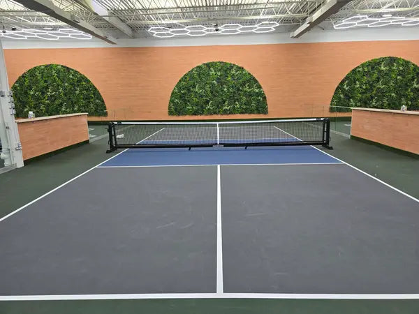 Indoor pickleball court green wall