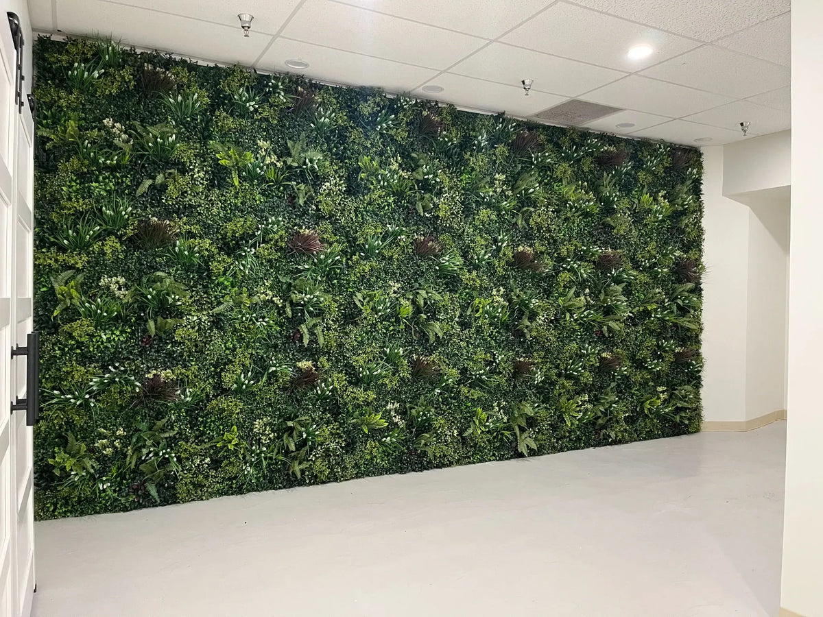 Modern commercial interior featuring a full-height Luxury Lush Spring artificial green wall with rich layered foliage and vibrant greenery for a natural statement look.