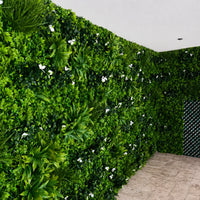 Close-up of Luxury White Oasis artificial vertical garden showing layered green leaves and subtle white flowers for a premium lush wall effect