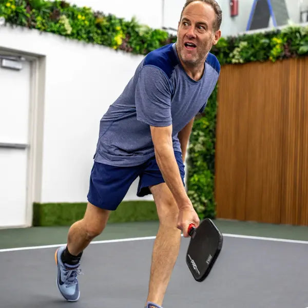 Man playing pickleball indoor court