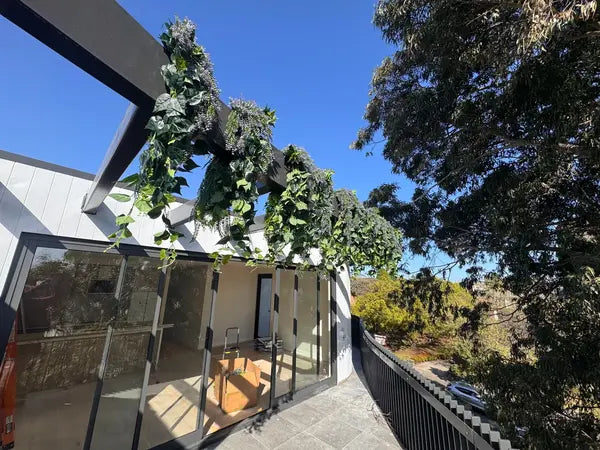 Uv resistant artificial hanging greenery on modern balcony