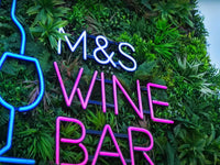 Business signage with green wall panels 