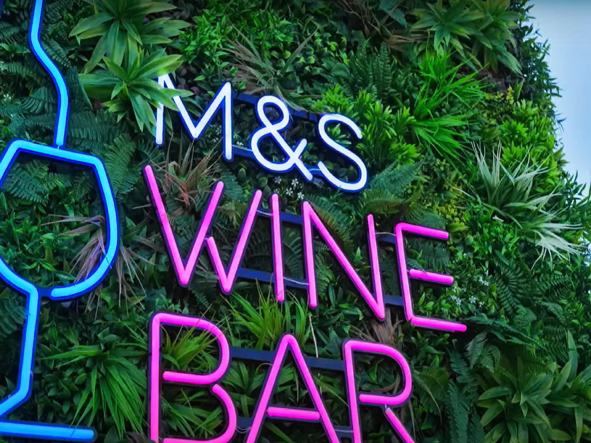 Plastic plant wall panels with business signage