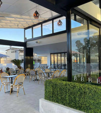 Light Artificial Boxwood Hedge Freestanding Event Hedge at a Diner