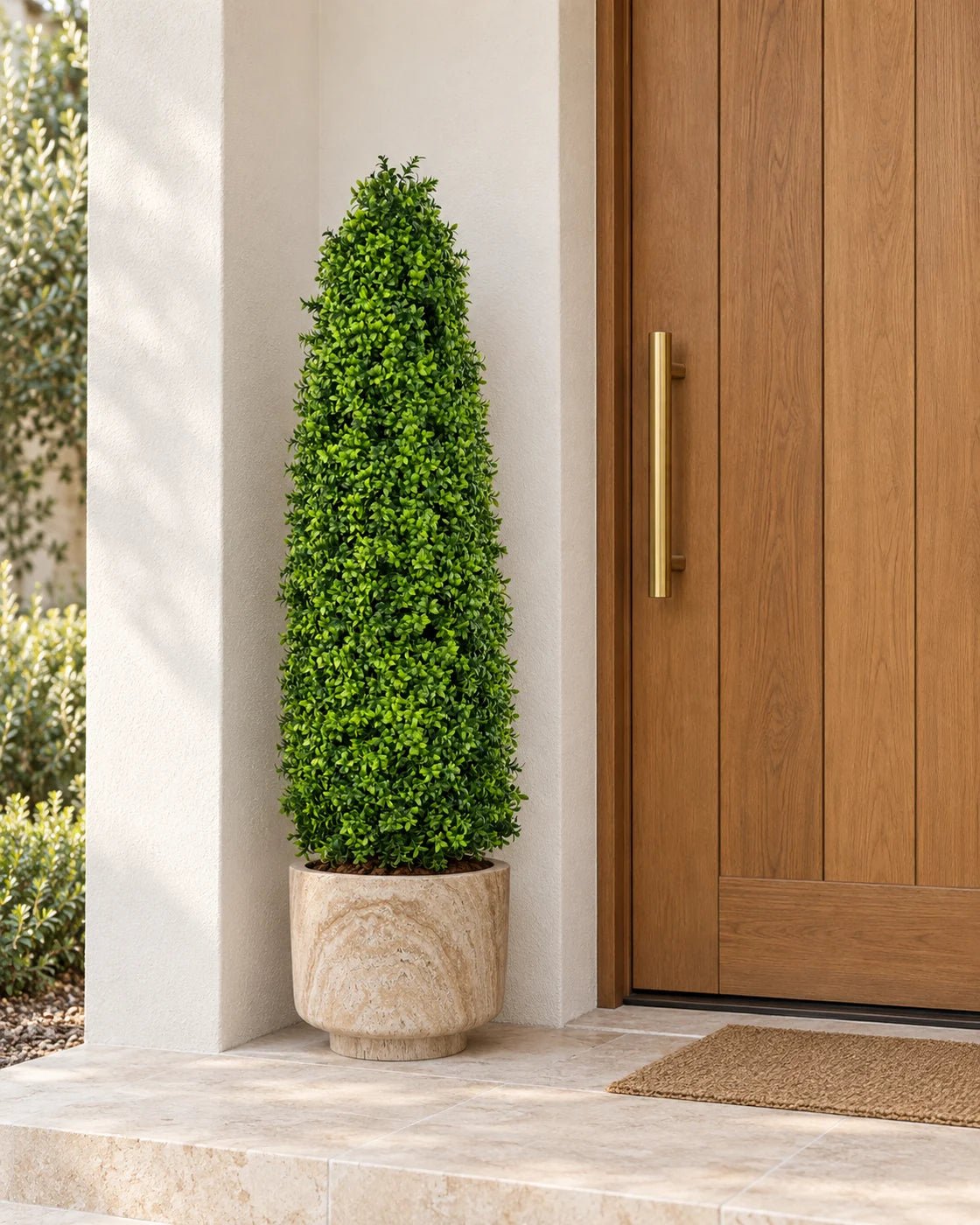 120 cm artificial Bright Buxus tree in a marble-effect pedestal planter beside a timber front door on a limestone doorstep.