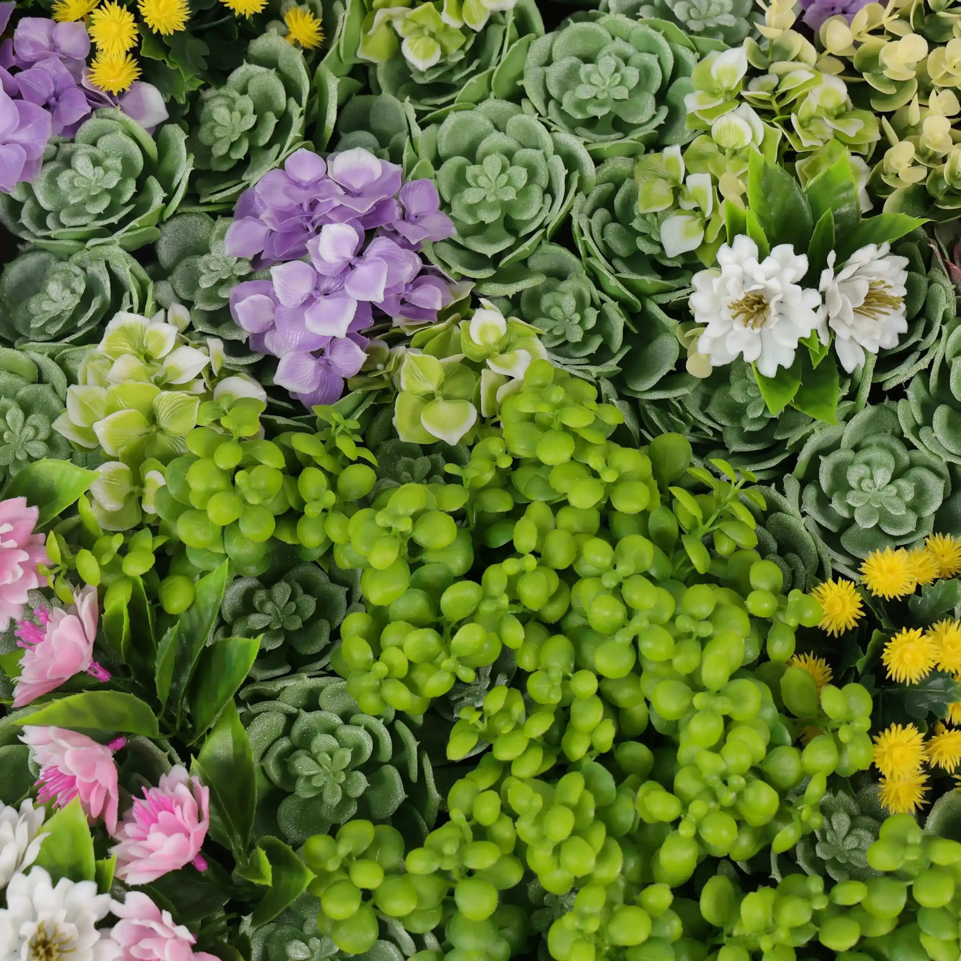 Mixture of artificial green succulents, purple flowers, and yellow and pink blossoms.