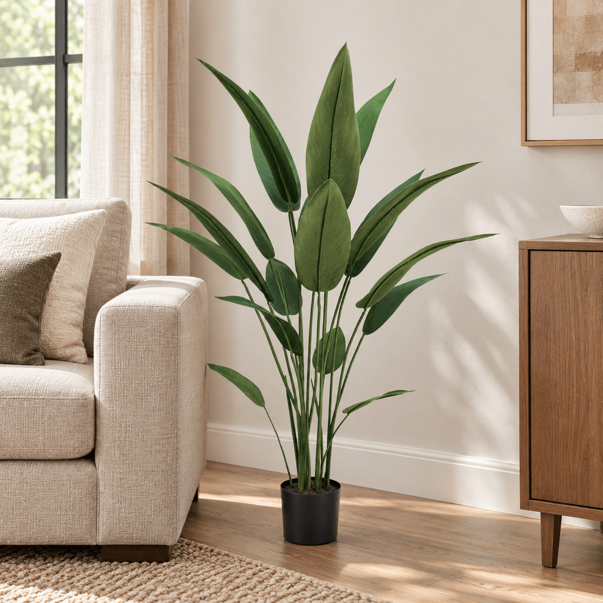 47.2-inch Bird of Paradise artificial tree in its black nursery pot in a contemporary living room