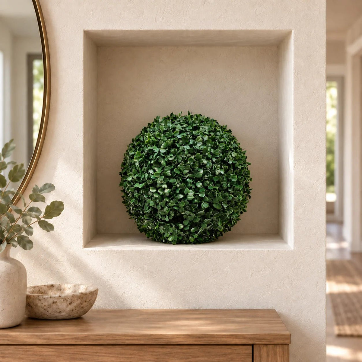 Artificial boxwood topiary ball in a square wall niche