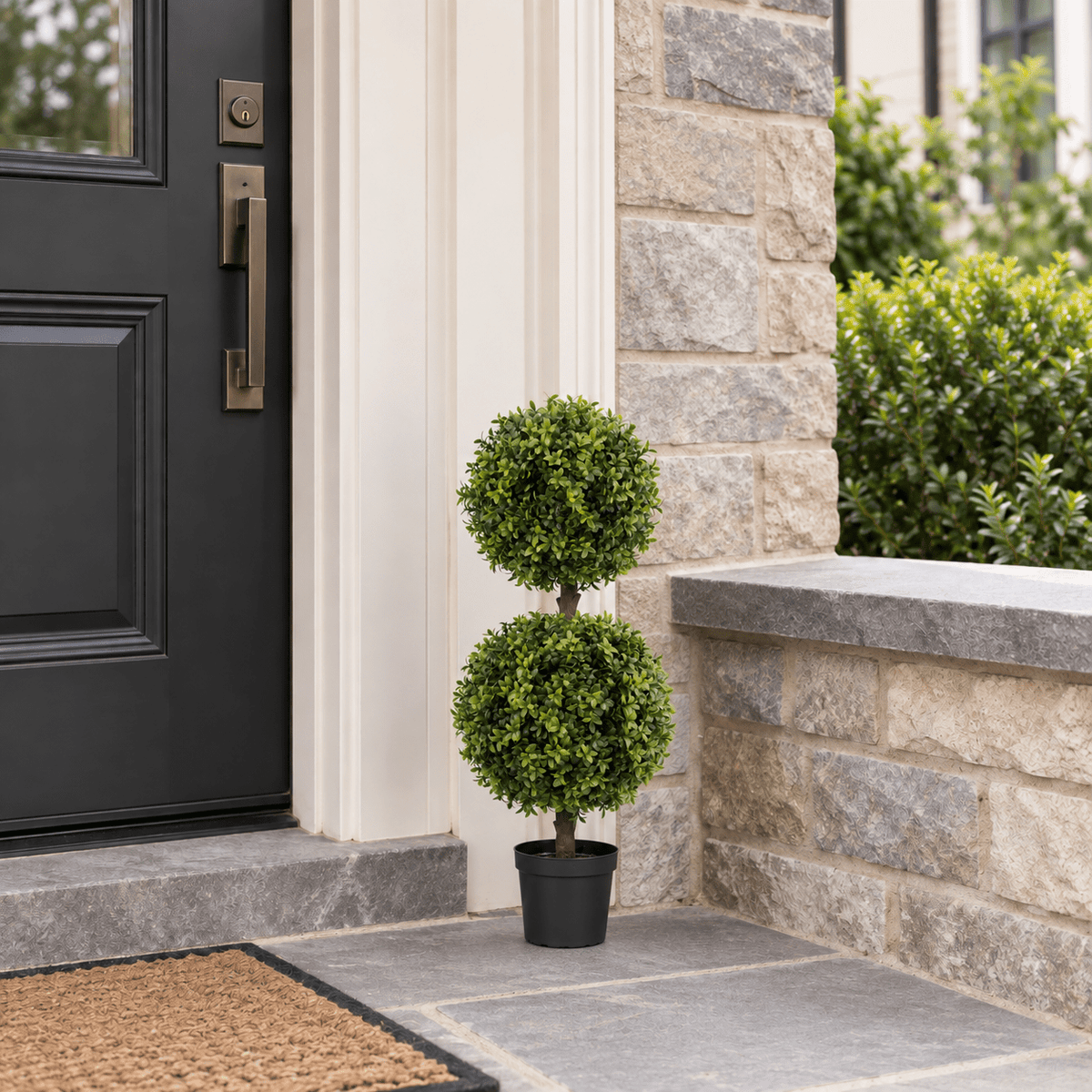 33-inch UV-resistant double-ball artificial topiary tree in its black nursery pot by a front door