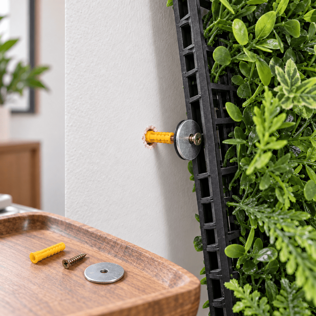Yellow wall plug, screw and washer installation for an artificial green wall panel on drywall