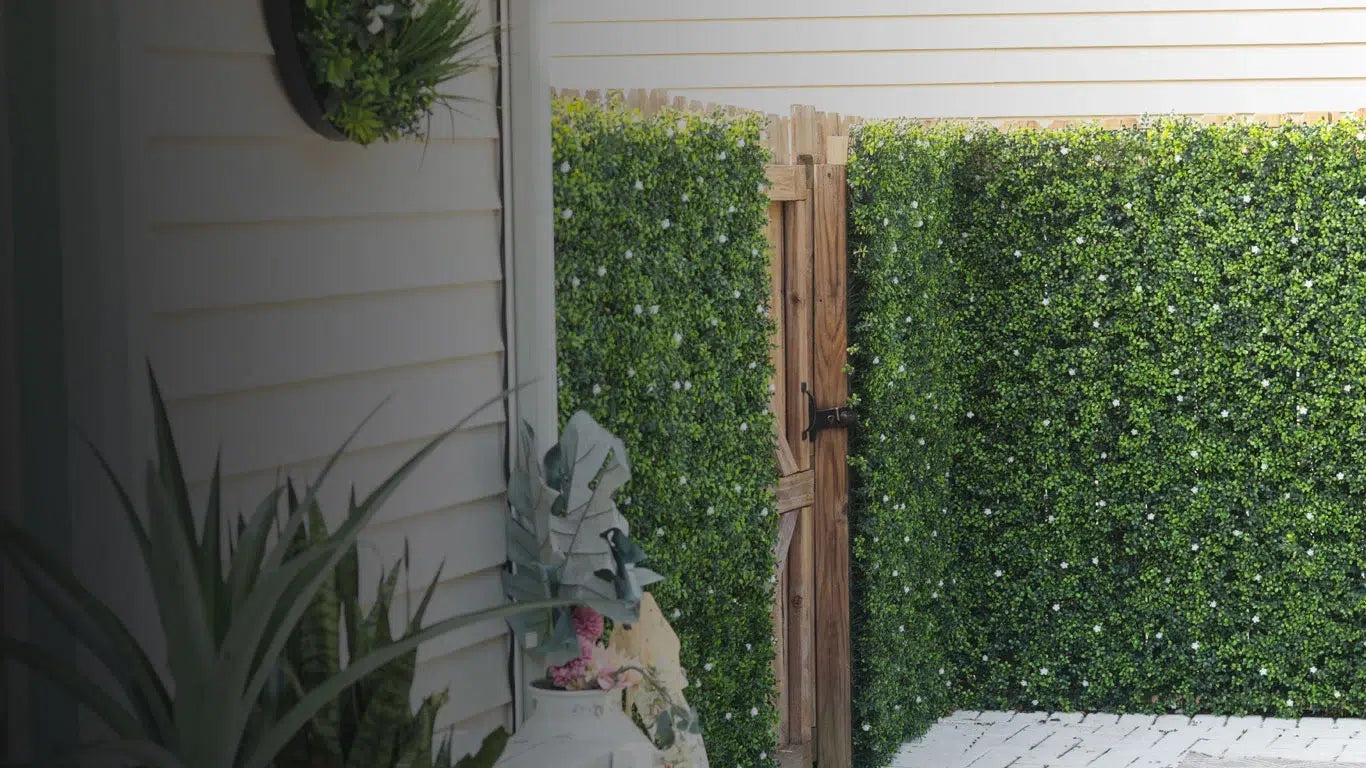 Ultra-realistic artificial green wall panels installed on outdoor fence and garden wall — Designer Plants USA