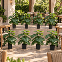 Set of eight 20-inch UV-resistant potted Monstera artificial plants on a covered outdoor restaurant patio