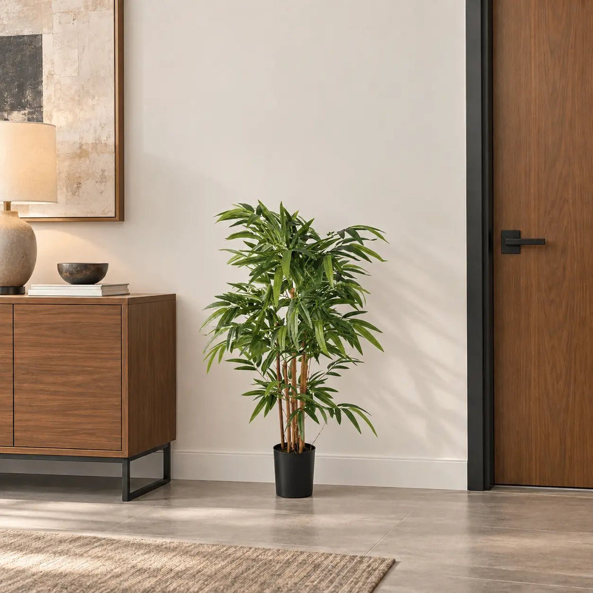 47.2-inch natural trunk Bamboo artificial tree in its black nursery pot in an indoor office lounge
