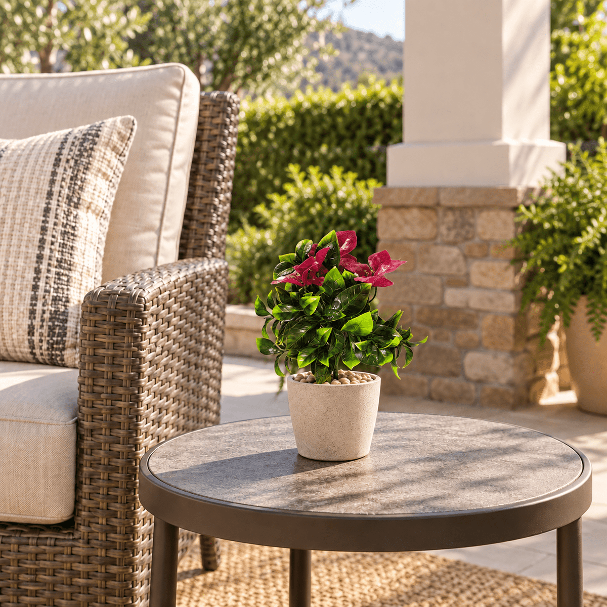 12-inch UV-resistant pink bougainvillea artificial stem in a small pot on a covered patio table