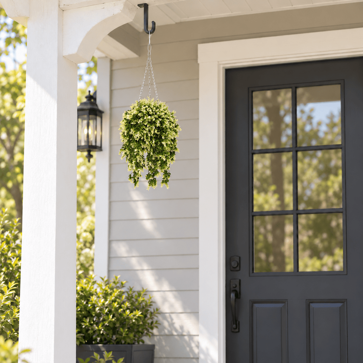 UV-resistant spring evergreen artificial hanging basket, approximately 17 inches across, on a covered porch