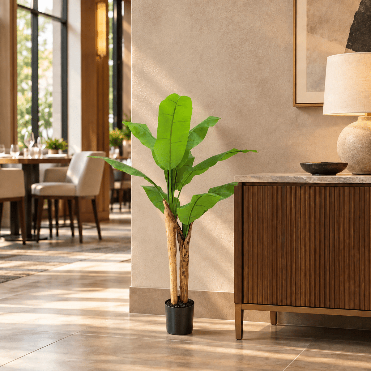 47.2-inch Wide Leaf Banana artificial tree in its black nursery pot in a restaurant interior