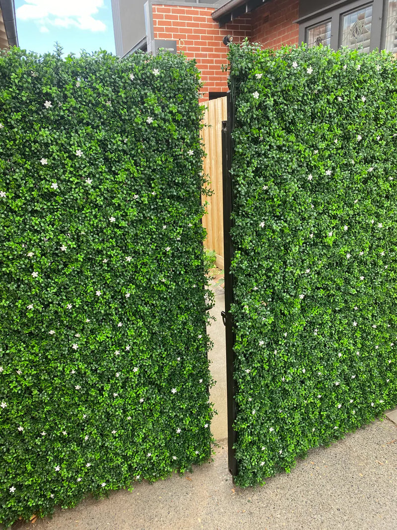 Faux Boxwood hedge panels installed onto a fence