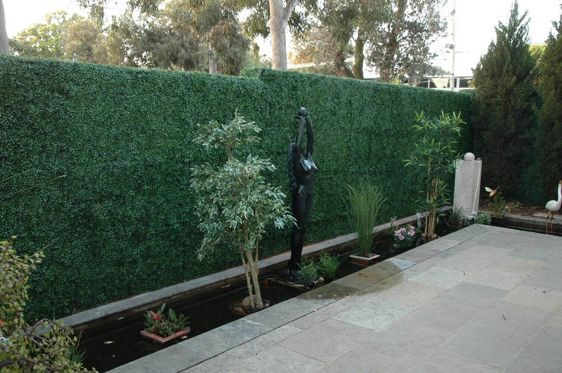 Artificial Boxwood Hedge Panels Installed Into a Miami Landscape backyard