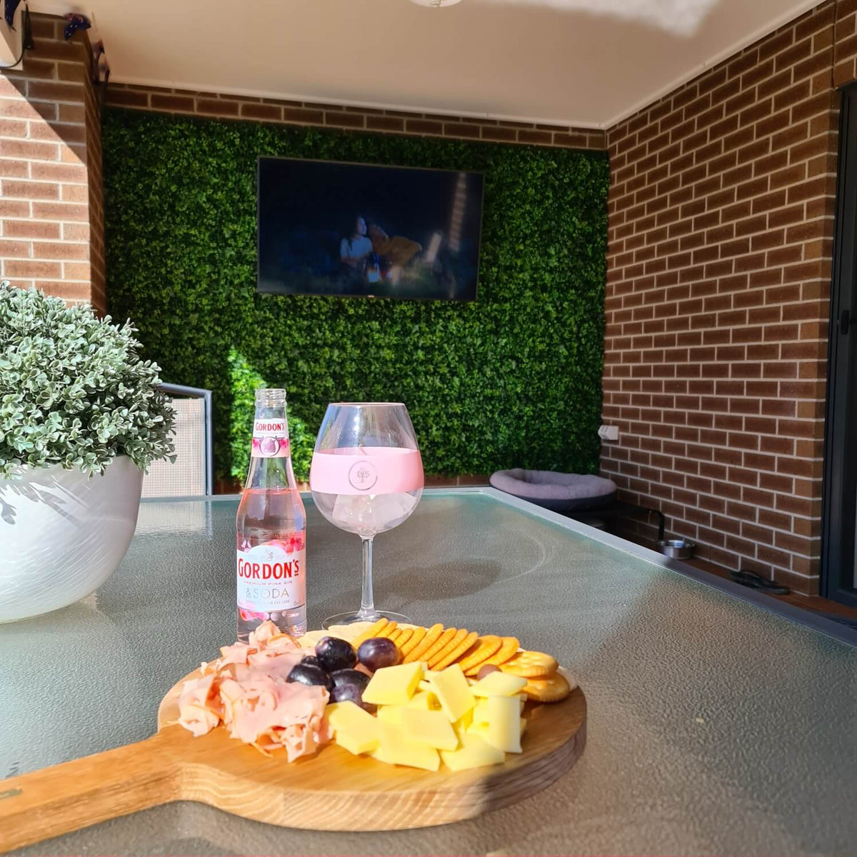 Artificial Ivy hedge panel installed on a patio wall in the backyard